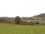  V 170 1125 am 29.10.2004 mit dem Schotterreinigungszug, in der Gegend von Moutfort bei der Arbeit